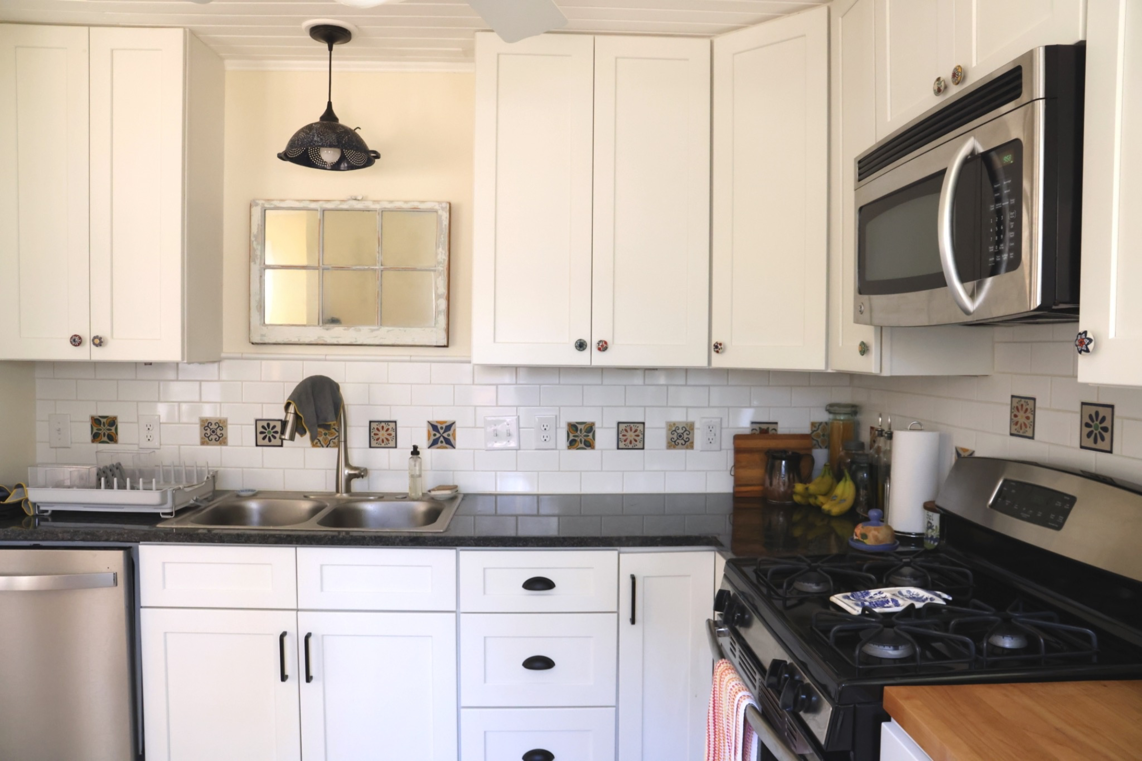 Emily's white cabinets with colorful finishes and backsplash