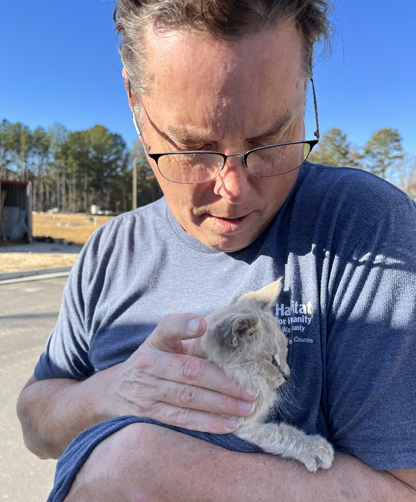 Construction Crew Leader comforts kitten