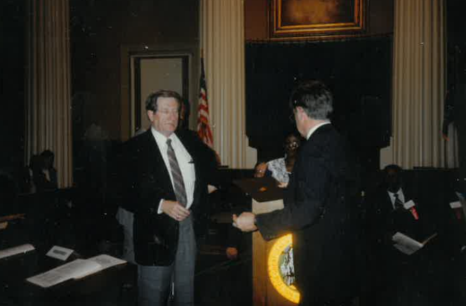 Dewey Alley accepting an award from Gov. Martin in 1988
