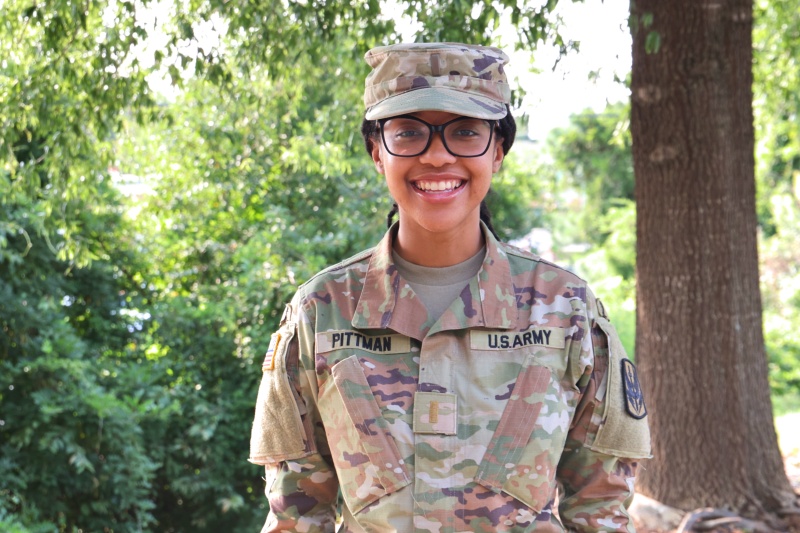 Bridget stands in uniform outside the Habitat Wake offices