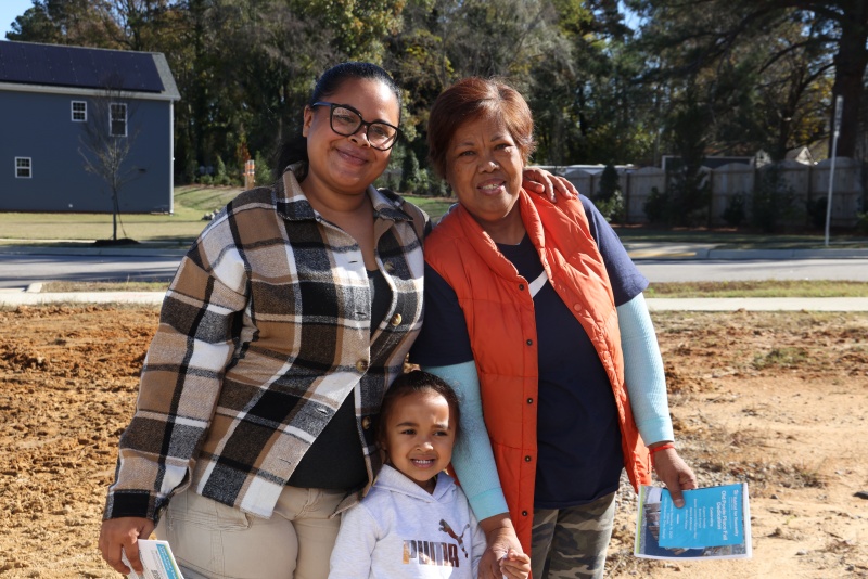 Eugenia stands with her mother and daughter at her Habitat Wake home dedication