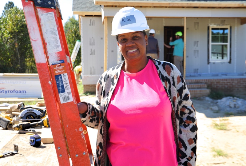 Habitat Homebuyer, Kai, stands on the construction site for her first day of sweat equity hours.