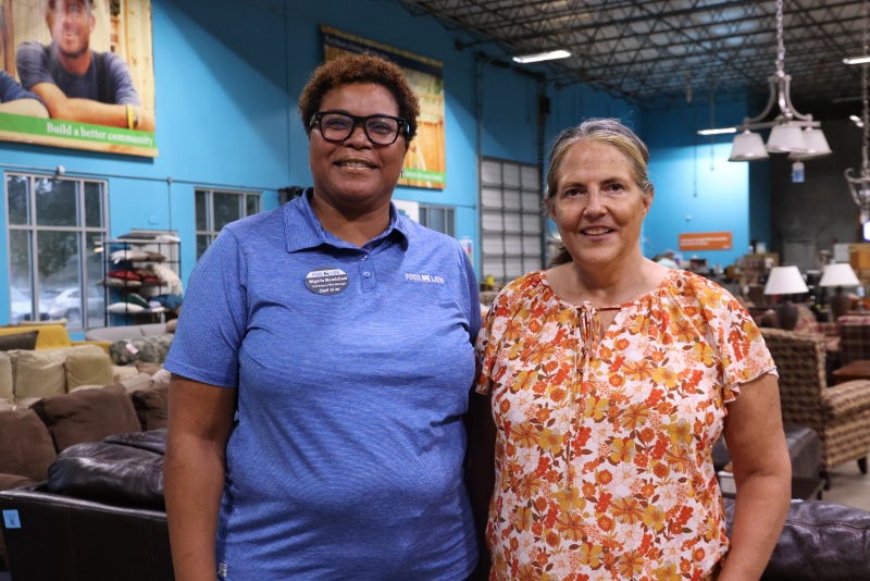 Nigeria McMichael (left) stands with her fellow volunteer and now coworker Beth 