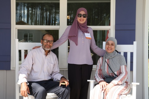 Homebuyer Hasna and her parents sitting on her porch