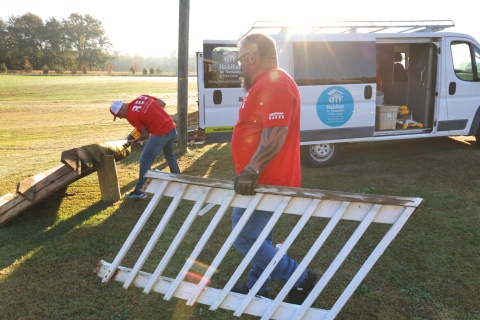 Volunteers work on a new deck for a veteran homeowner in Johnson County