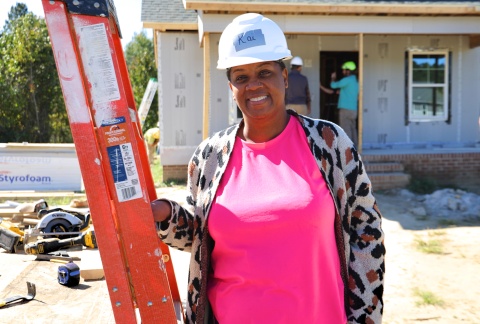 Habitat Homebuyer, Kai, stands on the construction site for her first day of sweat equity hours.